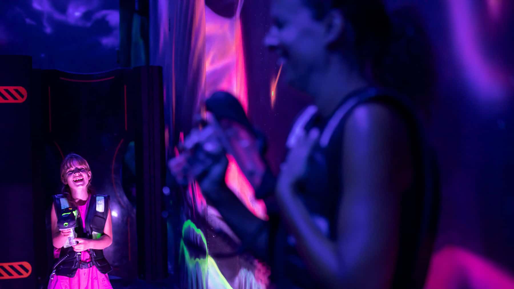 People enjoying indoor entertainment with vibrant lighting at Tremblant.