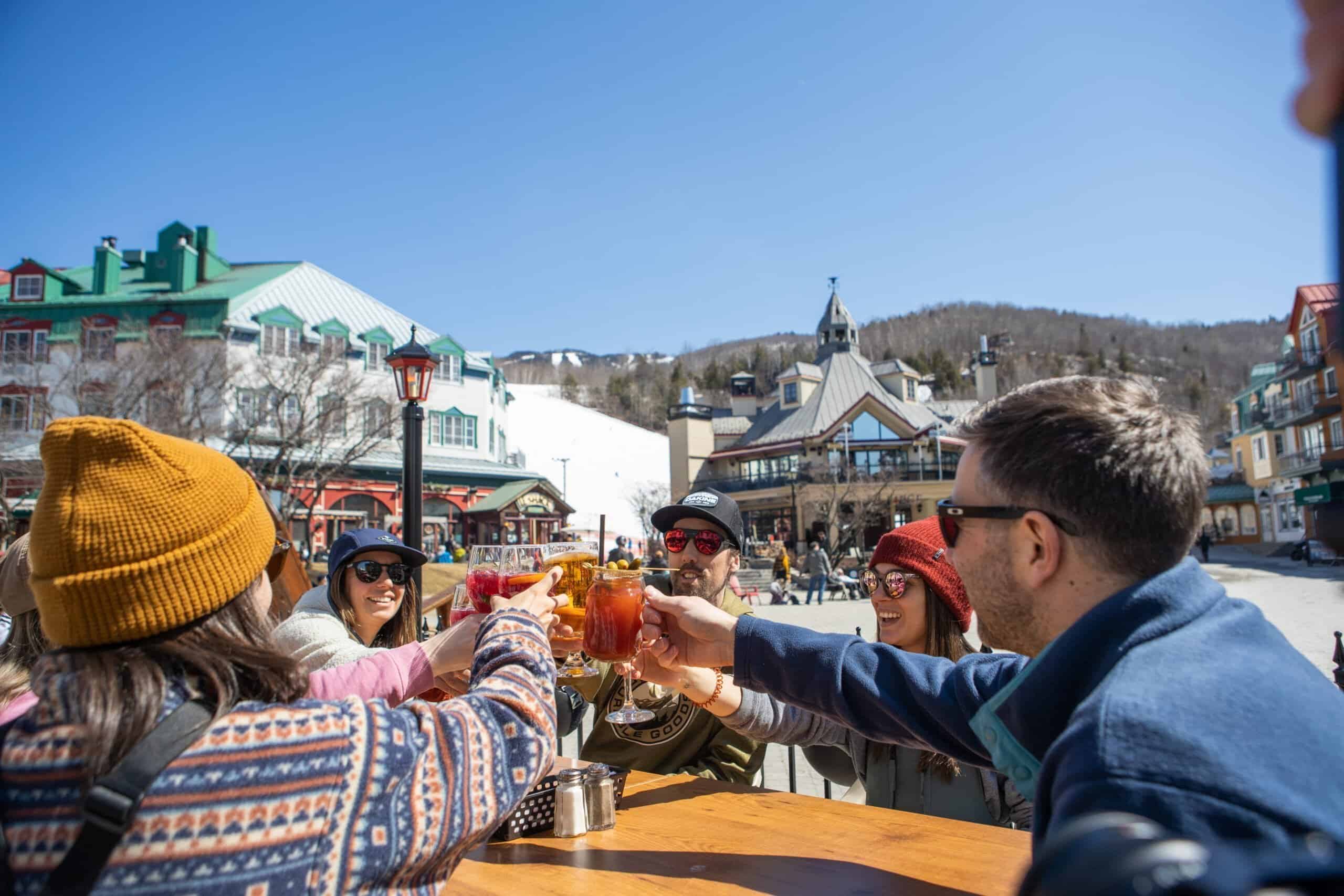 Amis trinquant avec boissons chaudes en plein air à Tremblant.