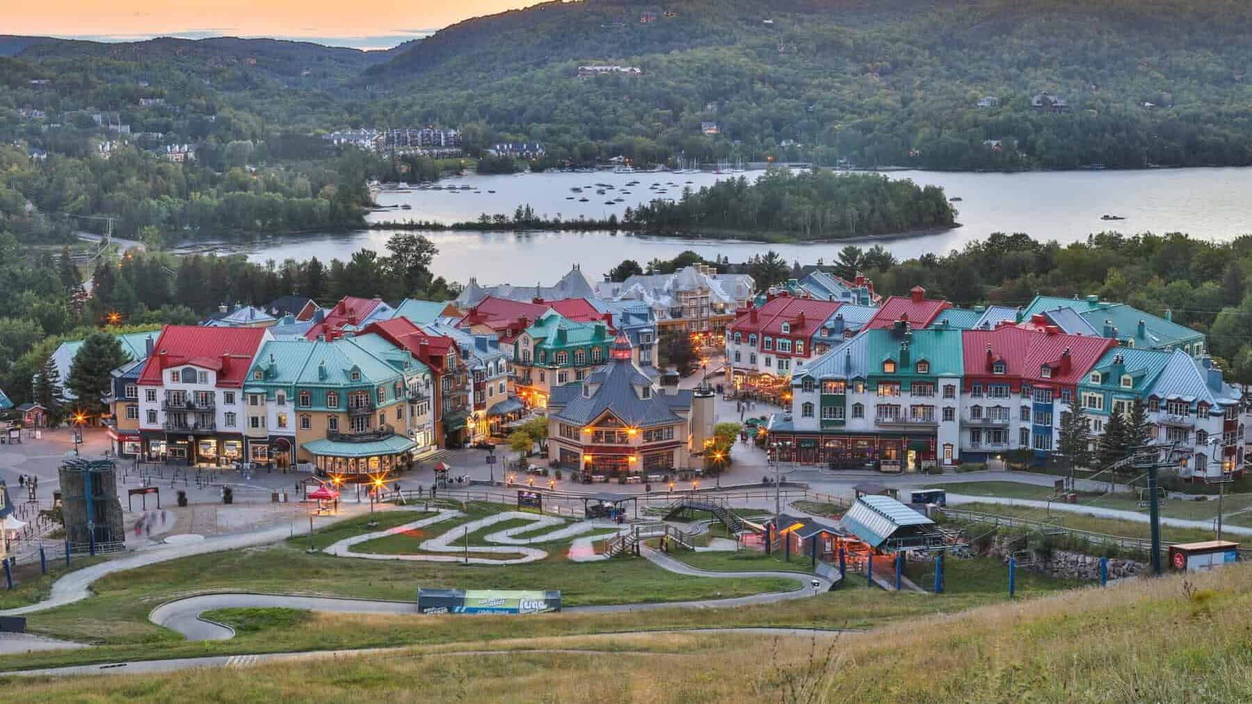 Colorful Tremblant village houses by the lake at sunset.