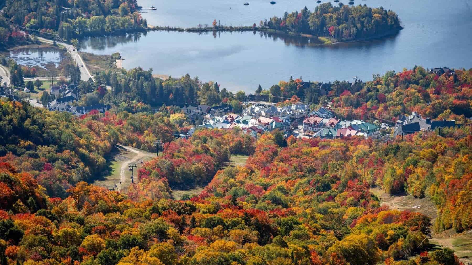 Autumn foliage over Tremblant village and lake landscape.