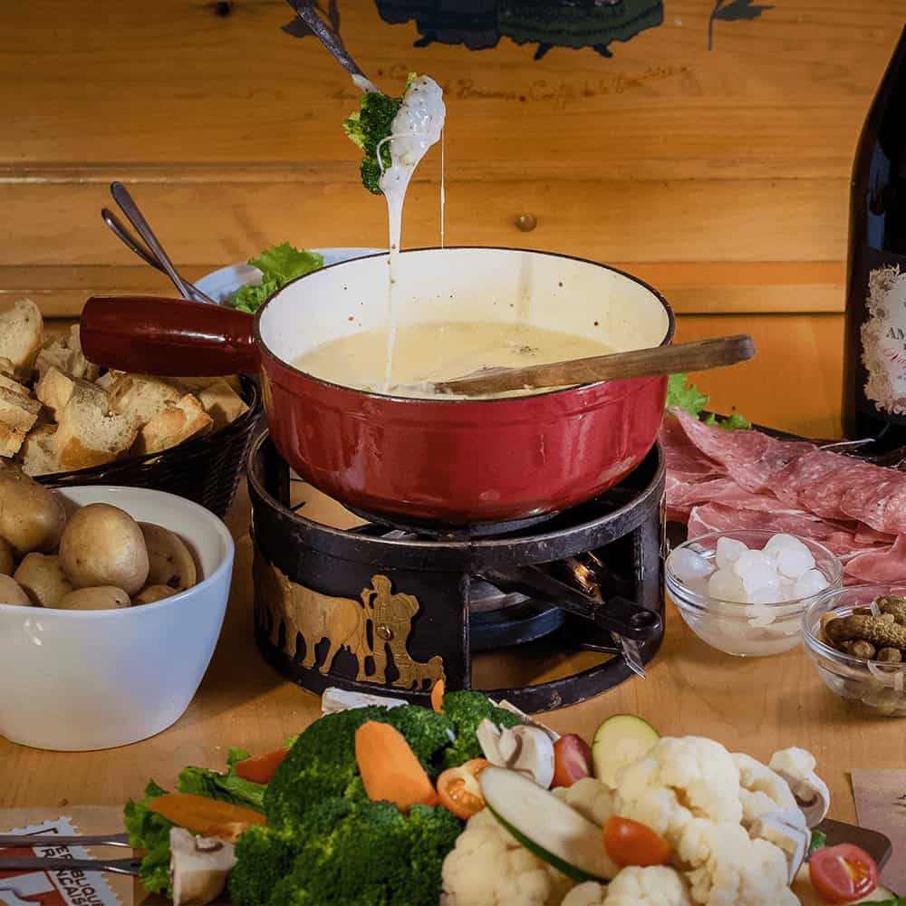 Warm cheese fondue with vegetables and bread in Tremblant.