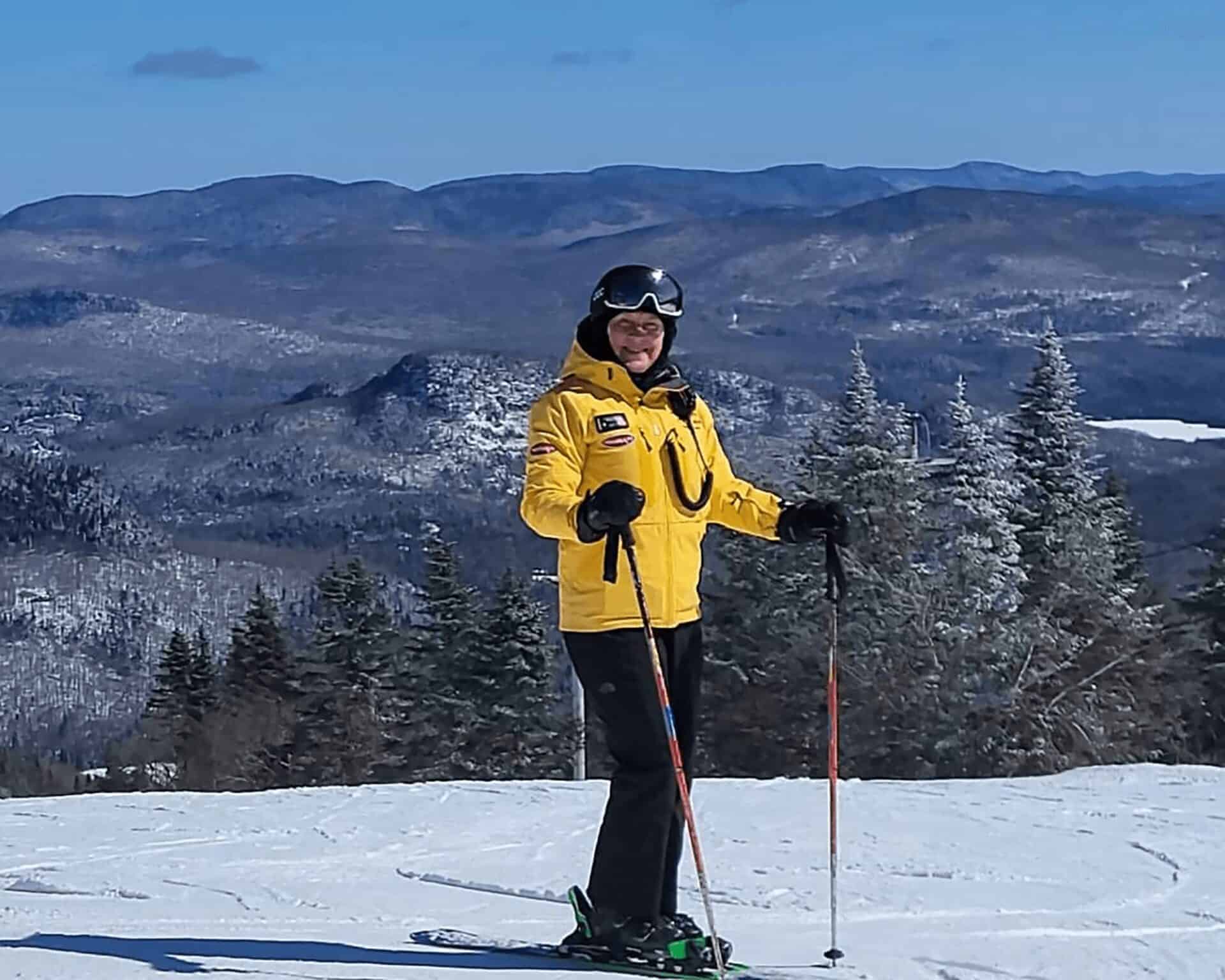 Skier in yellow jacket enjoying Mont Tremblant's snowy slopes.