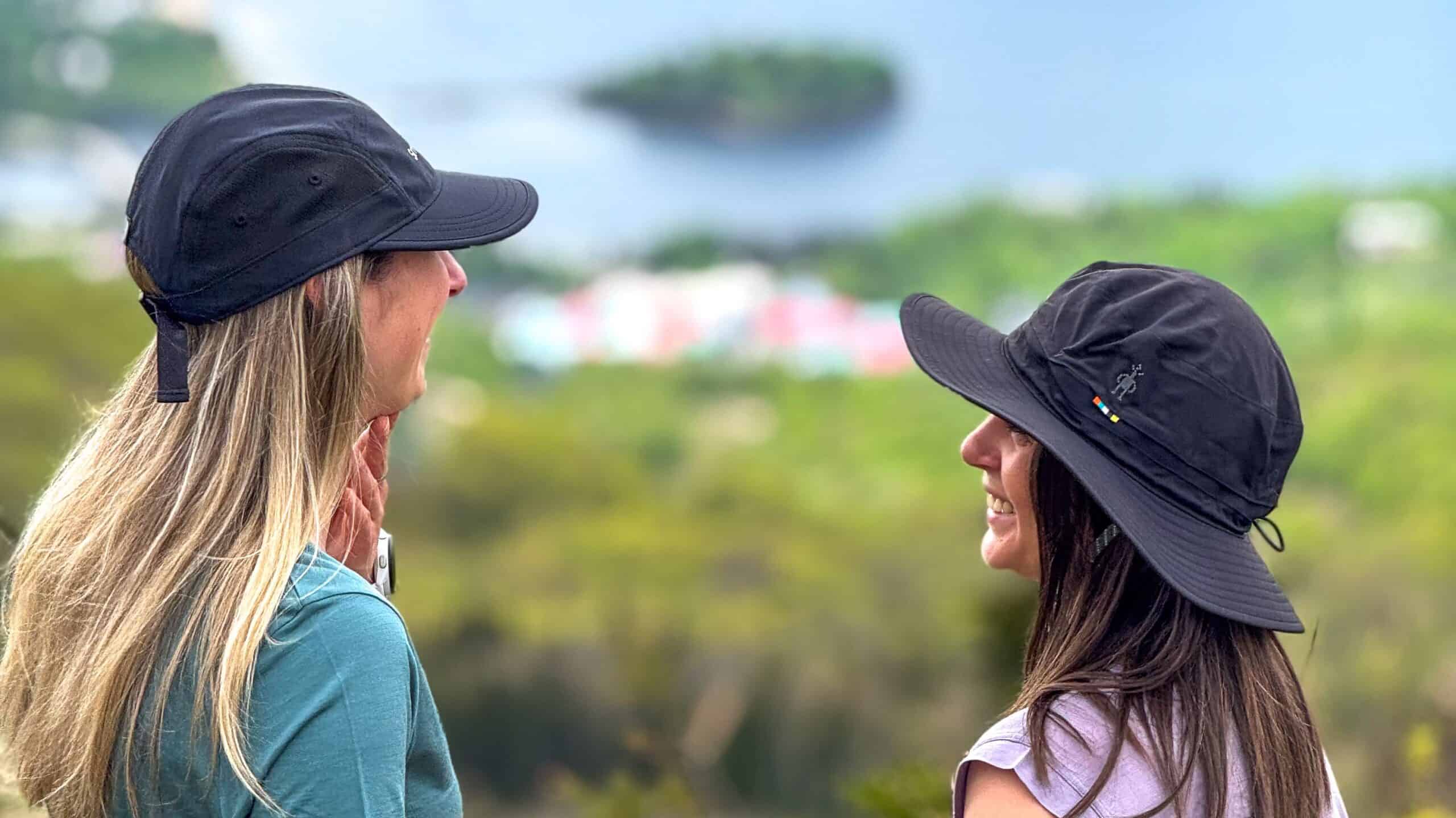 Two women hiking in Tremblant with scenic lake view in background.