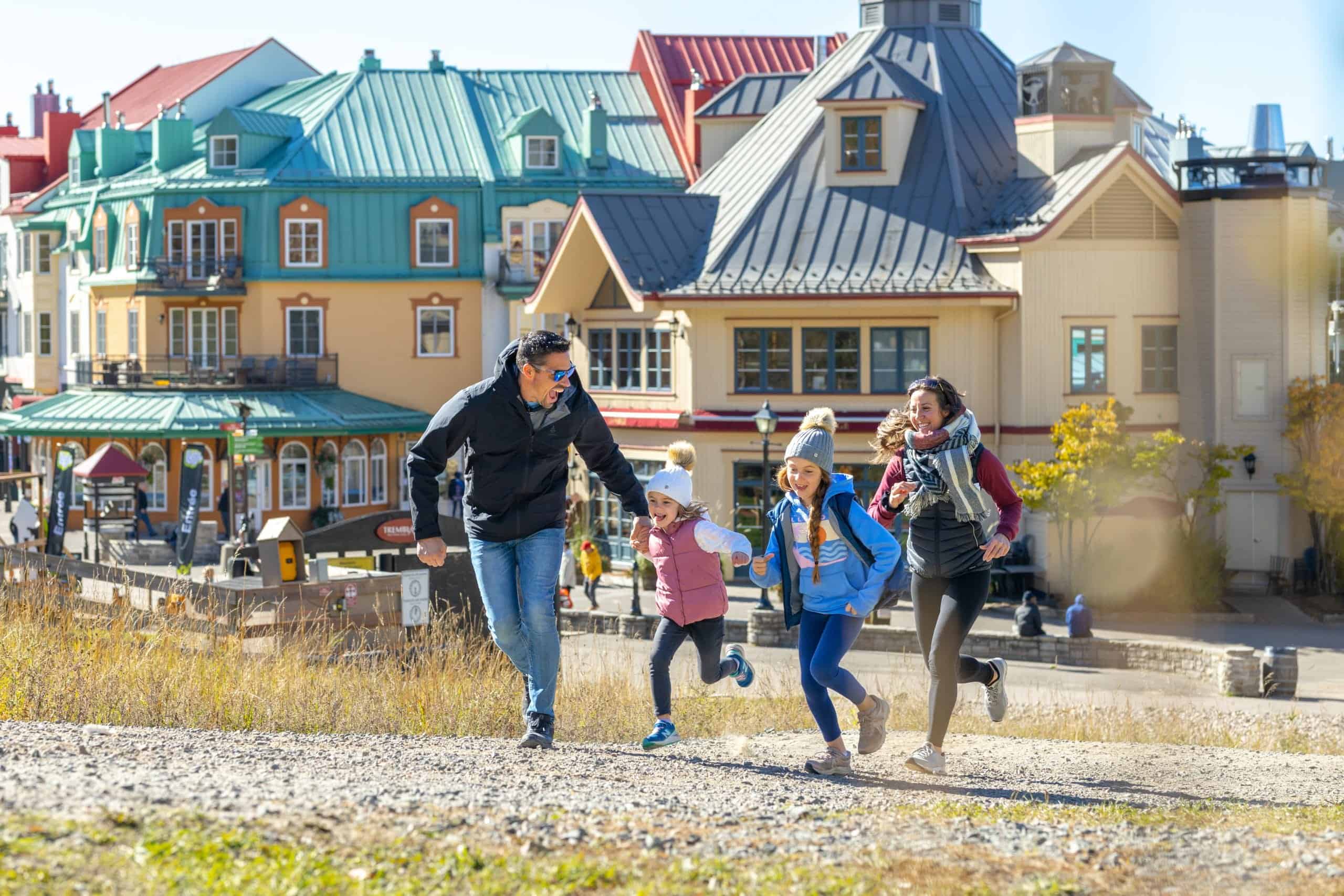 Family enjoying a walk in Tremblant's colorful village during fall.