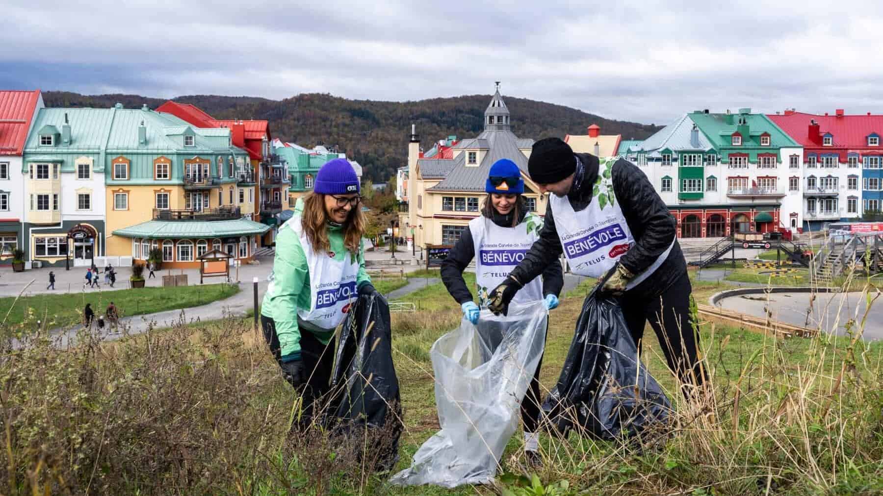 Groupe de bénévoles ramassant des déchets dans un espace naturel près du village coloré de Tremblant.