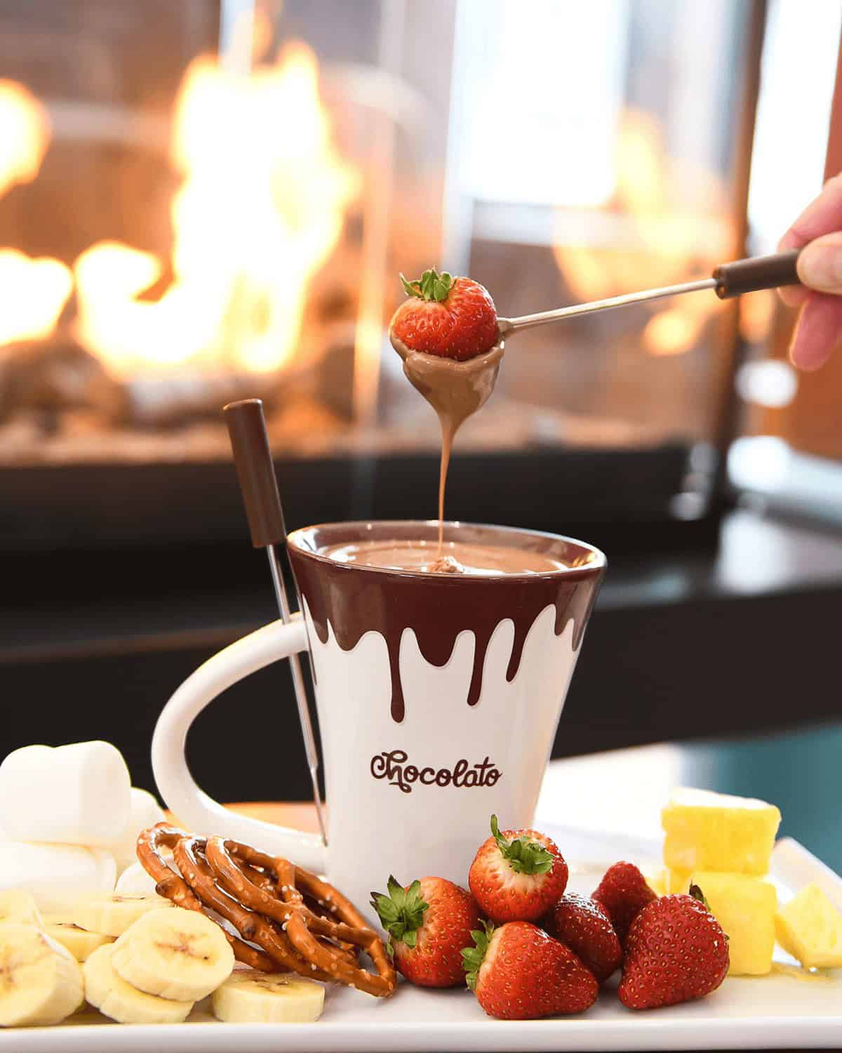 Delicious hot chocolate with strawberries and snacks in Tremblant cafe.