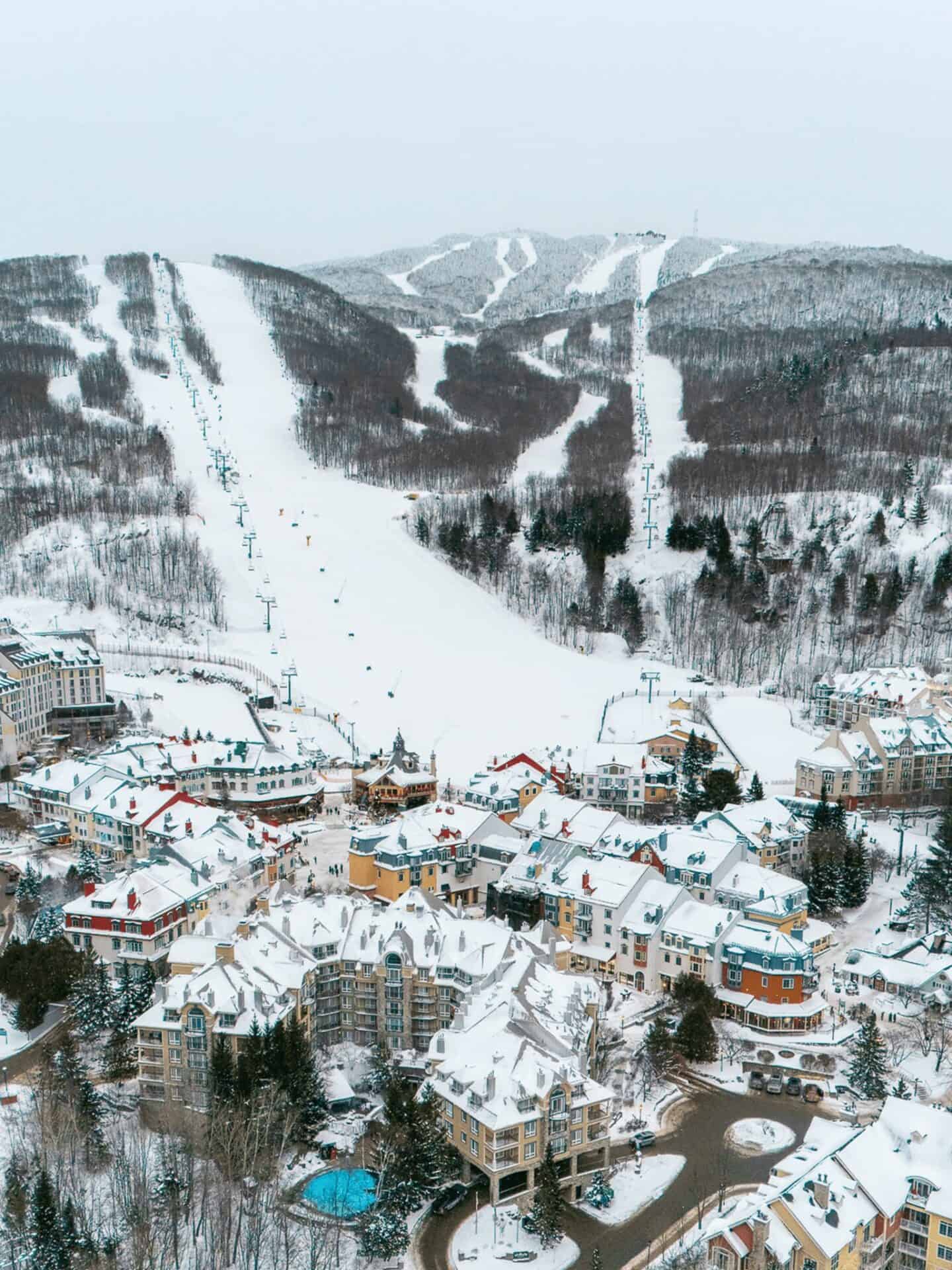 Snow-covered ski slopes and village in Mont-Tremblant during winter.