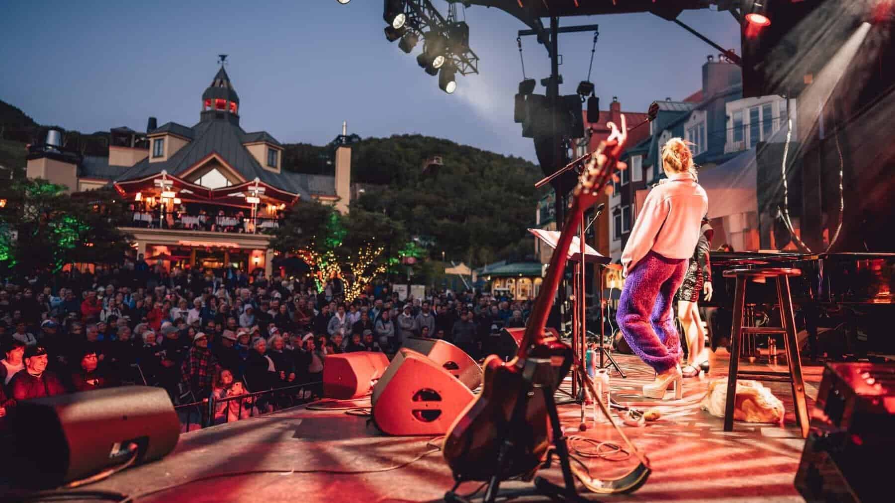 Musical performance on stage with crowd at Tremblant festival.