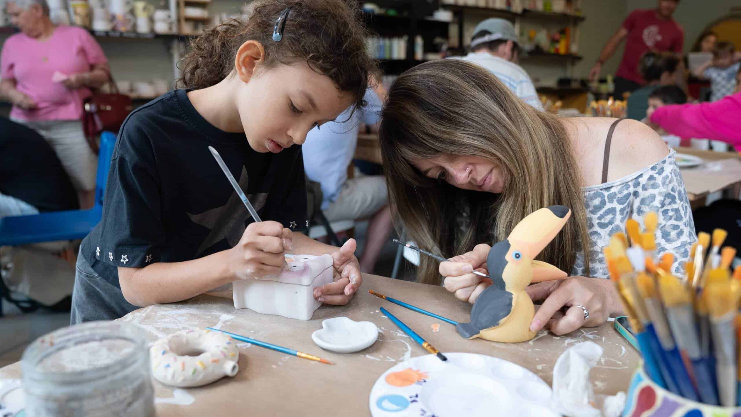 Children and adult creating crafts at a family workshop in Tremblant.