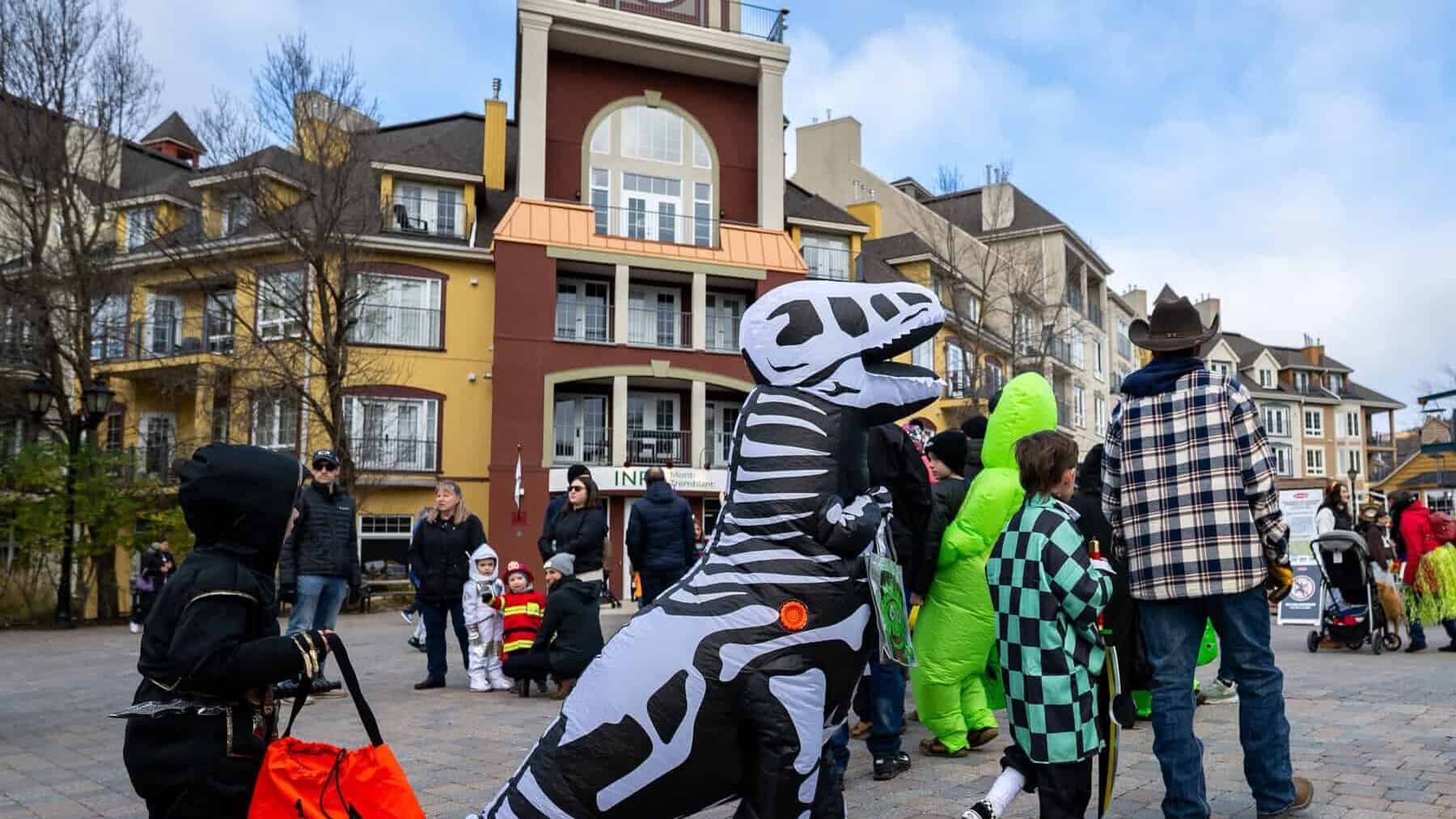 People in Halloween costumes in a picturesque square in Tremblant.